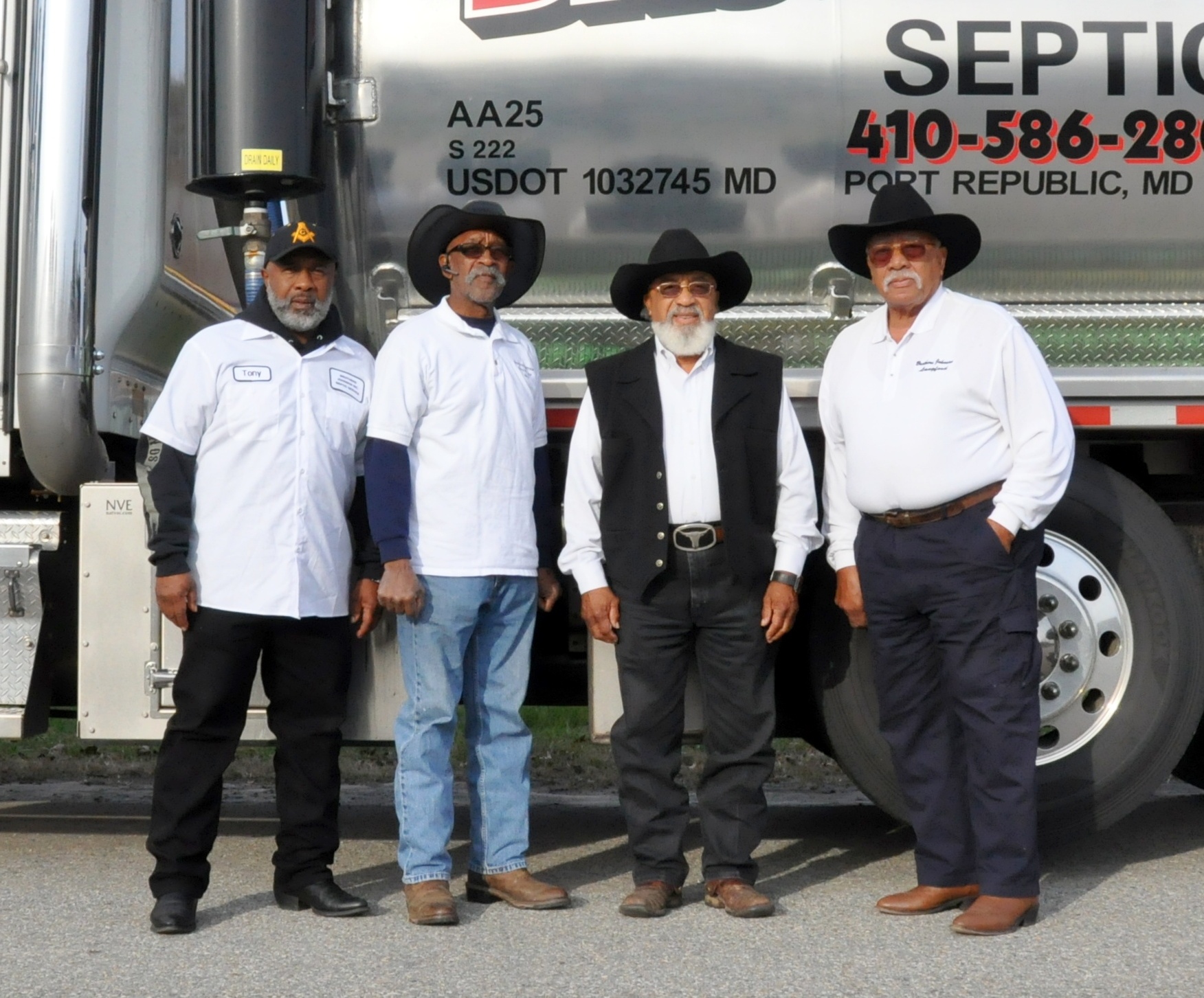 The four Johnson brothers in front of the chrome Brother's Johnson septic tanker